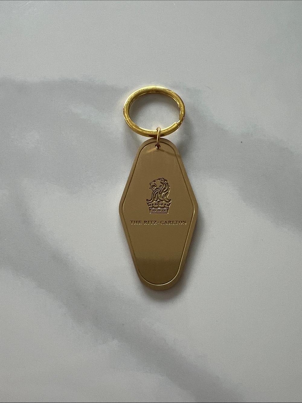 Merit Beauty Ritz Carlton Gold Keychain